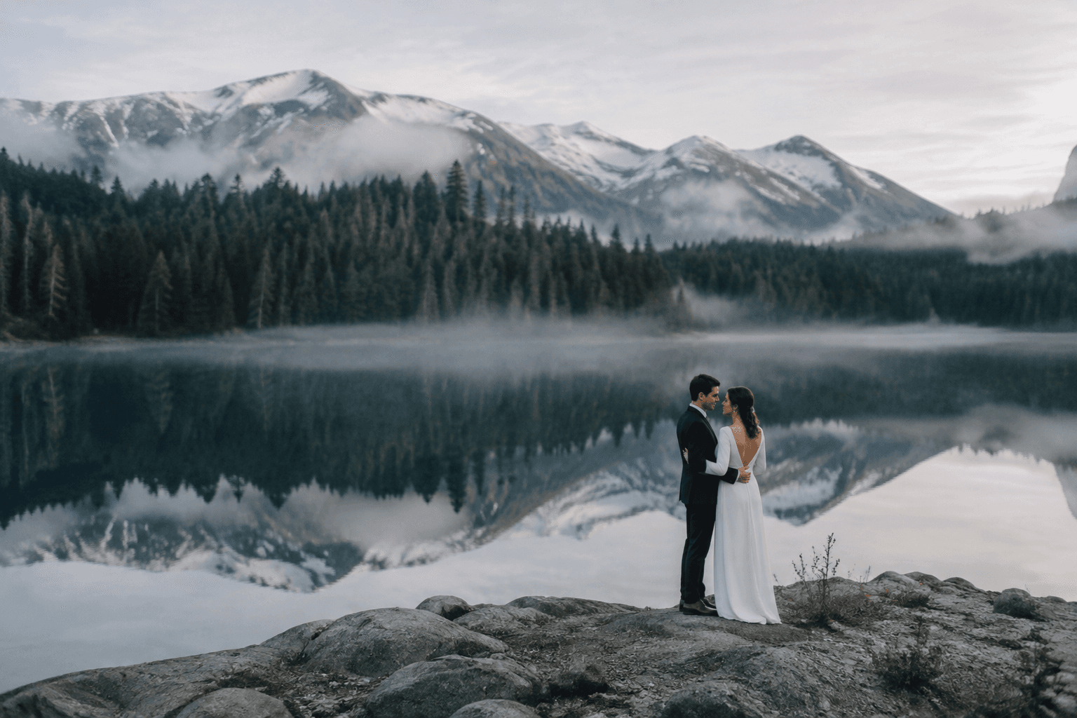 A newly married couple beside a mountain lake near Whistler